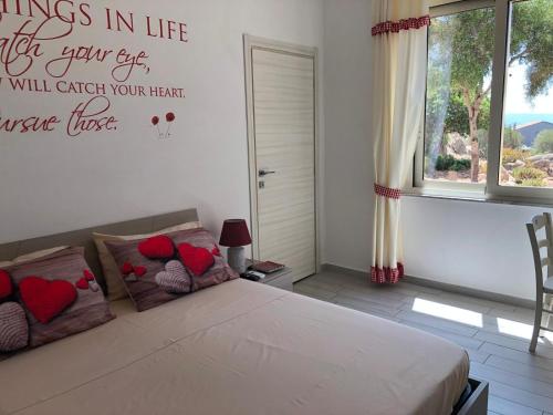 a bedroom with a bed with hearts on the wall at B&B Isola Mia in La Maddalena