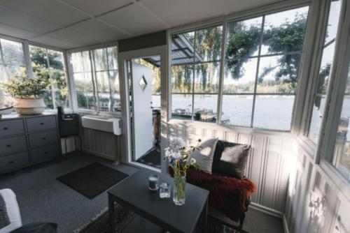 a living room with a view of the water at Serene lakeside cabin next to the sea just 10 minutes from Stockholm city in Solna