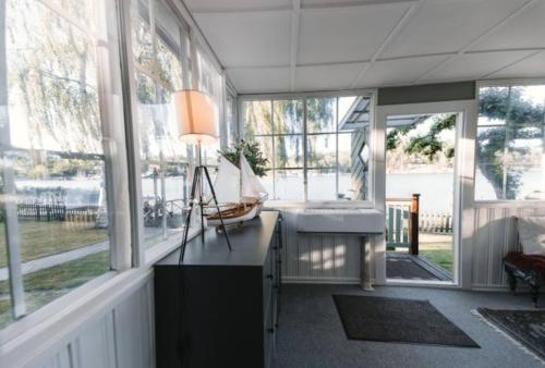 a large room with a sink and a large window at Serene lakeside cabin next to the sea just 10 minutes from Stockholm city in Solna