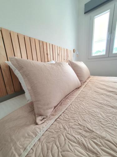 a bed with pillows on it in a bedroom at Julia's Home in Patitiri
