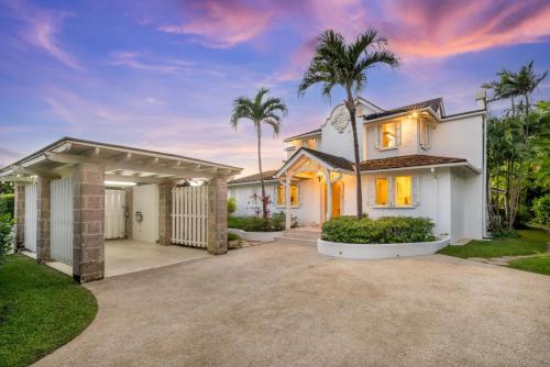 a house with palm trees and a driveway at Royal Westmoreland - Villa Grove home in Saint James