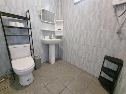 a bathroom with a toilet and a sink at Serenity House with Large terrace in Ban Nok