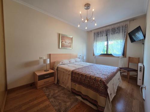 Ένα ή περισσότερα κρεβάτια σε δωμάτιο στο Apartamento Sanxenxo playa