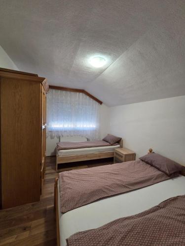 a bedroom with two beds and a ceiling at Biser-Hatinac in Bihać