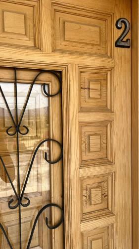 a wooden door with a window with the number on it at Apartamentos el Olivo in Trias