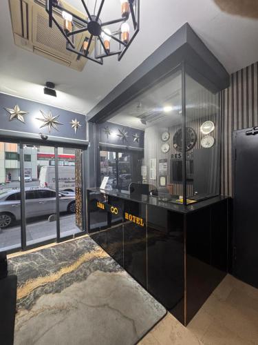 a room with a desk with a clock on the wall at Lina Suit Hotel in Istanbul
