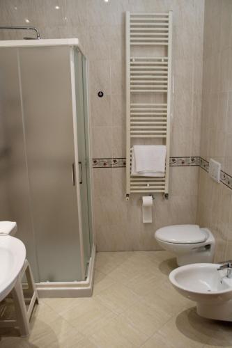 a bathroom with a shower and a toilet and a sink at Al Brenta in Levico Terme