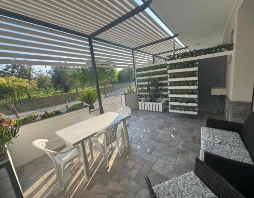 a patio with a table and chairs on a patio at CASA VACANZA BORGOROSSO A 70mt DAL MARE in Casa Borgorosso