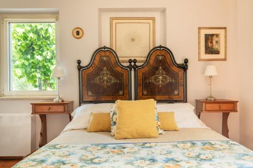 a bedroom with a bed with a large headboard at Borghetto Sant’Angelo in Soriano nel Cimino