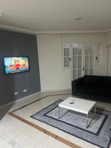 a living room with a couch and a coffee table at Appartement nasria in Sfax