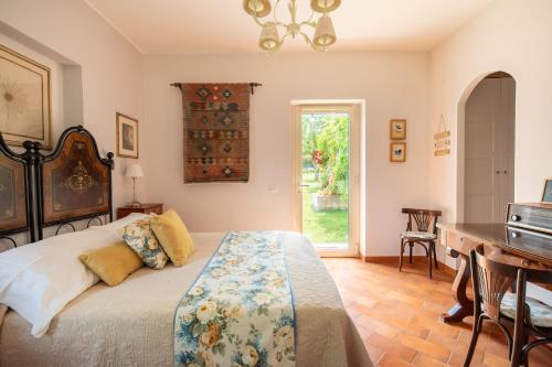 a bedroom with a bed and a table and a desk at Borghetto Sant’Angelo in Soriano nel Cimino