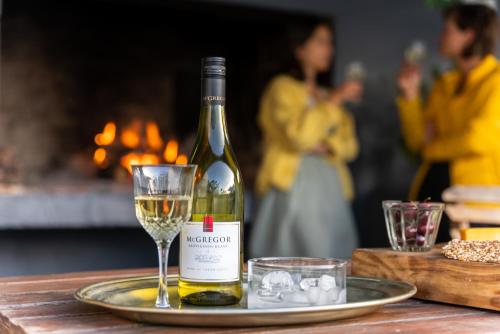 a bottle of white wine and a glass on a table at The Old School in McGregor