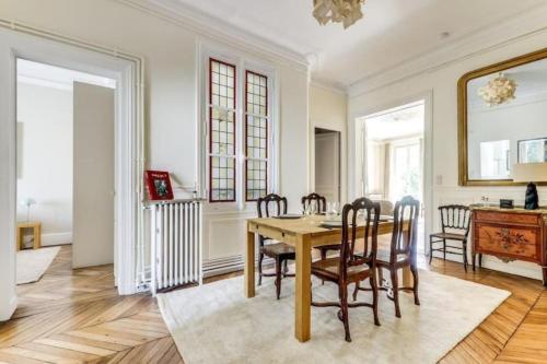 une salle à manger avec une table et des chaises dans l'établissement La Fleur du Bosquet - Sumptuous- Eiffel Tower view, à Paris