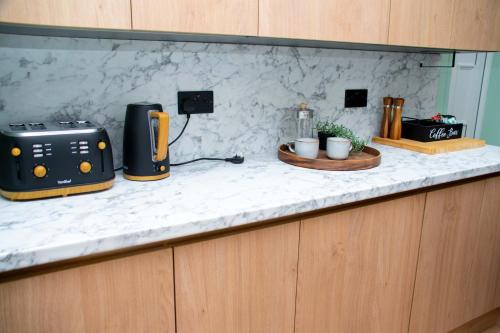 a kitchen counter with a toaster and a toaster at Sleeps 14 The Old Trafford Family Zen by Genesis Living in Manchester