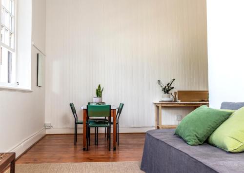 a living room with a table and chairs and a bed at The Old School in McGregor
