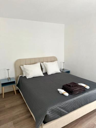 a bedroom with a large bed with two tables at Casa do Viriato in Guarda