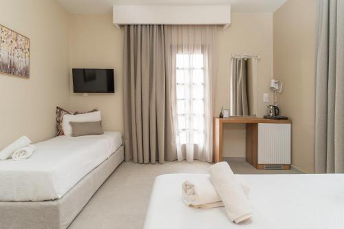 Ένα ή περισσότερα κρεβάτια σε δωμάτιο στο Georgalas Sun Beach Resort