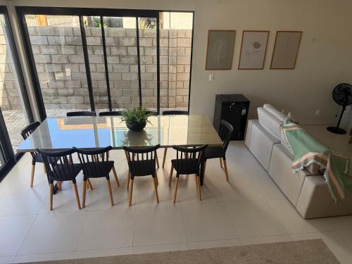 a living room with a table and chairs and a couch at Casa Tibau in Tibau