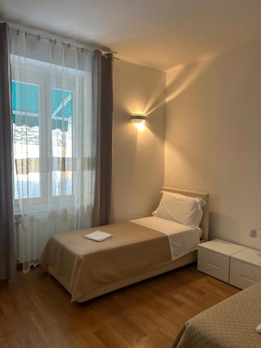 En eller flere senge i et værelse på Appartamento Alba