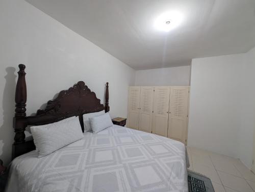 a bedroom with a large bed with white sheets at TwentyFive at Tower Isle in Tower Isle