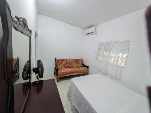 a small room with a bed and a couch at TwentyFive at Tower Isle in Tower Isle