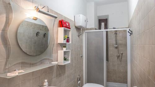 a bathroom with a mirror and a toilet and a shower at Casa di Olga - Historical Apartment inside the Walls in Lucca