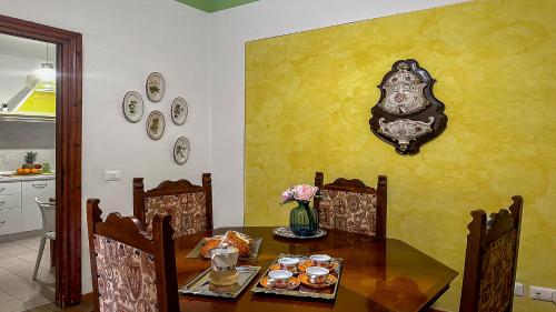 a dining room with a table with food on it at Casa di Olga - Historical Apartment inside the Walls in Lucca