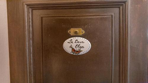 a door with a sign that says it has a load of love at Casa di Olga - Historical Apartment inside the Walls in Lucca