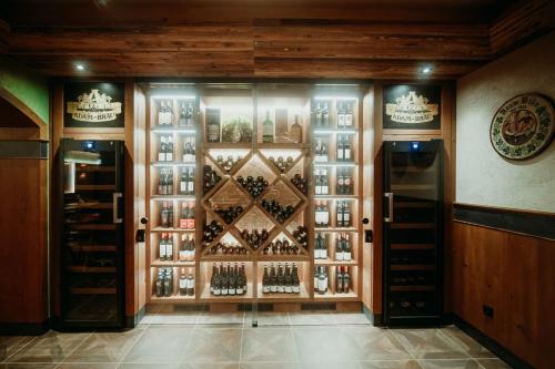a wine cellar with a wall of wine bottles at Wellness- und Bierhotel Adam Bräu in Bodenmais