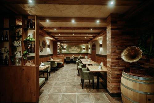 a dining room with tables and chairs in a restaurant at Wellness- und Bierhotel Adam Bräu in Bodenmais