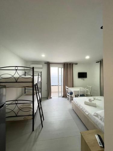 a bedroom with two bunk beds and a balcony at Villa Besnik in Sarandë