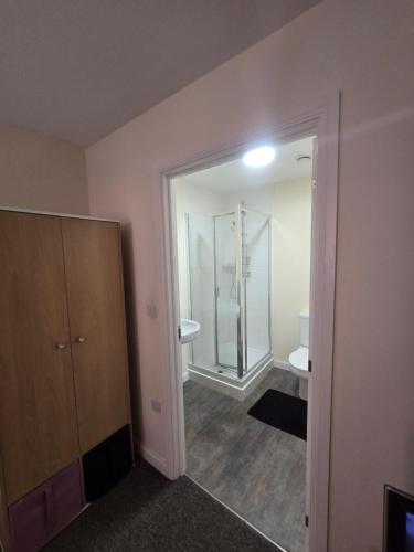 a bathroom with a shower and a glass door at Ensuite room in Wolverhampton city center in Wolverhampton