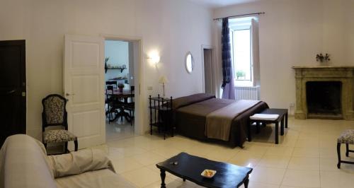a living room with a bed and a couch at Flora Rooms in Campobasso