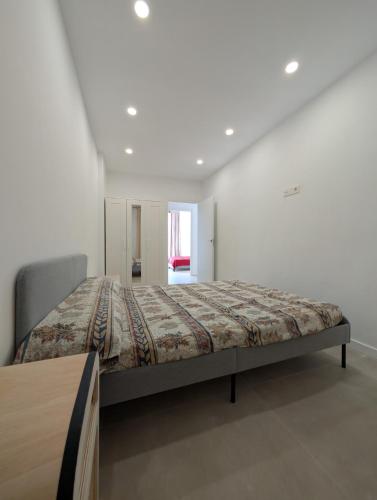 a bedroom with a bed in a white room at Ca l'Emília, hasta 6 pers, Monistrol de Montserrat in Monistrol