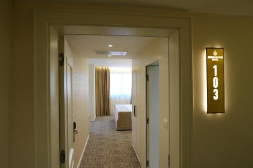a hallway of a hotel room with a sign on the wall at Avdissons Hotel in Prizren