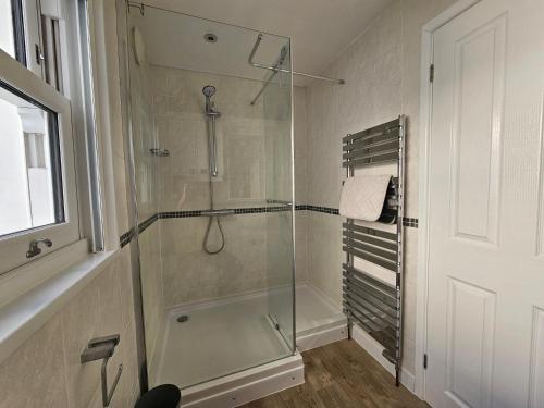 a shower with a glass door in a bathroom at The Nest in Weymouth in Weymouth
