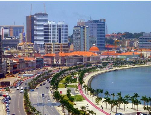 a city with a beach and a city with tall buildings at Citycomfortluanda in Luanda