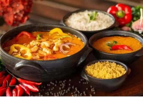 a group of bowls of food on a table with rice at Citycomfortluanda in Luanda