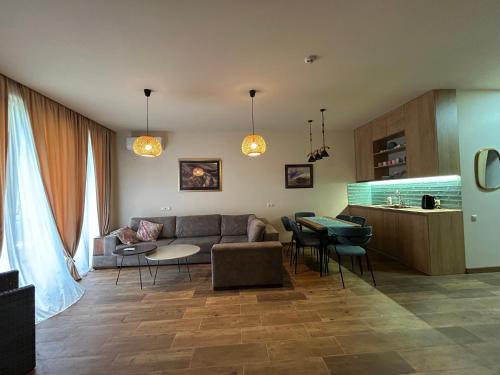 a living room with a couch and a table at Bamboo beach tsikhisdziri in Tsikhisdziri