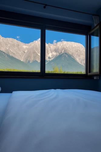 a bedroom with a bed and a view of mountains at Luxuriöse 120qm Ferienwohnung mit Panoramablick in Barwies