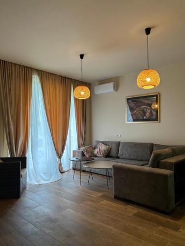 a living room with a couch and a table at Bamboo beach tsikhisdziri in Tsikhisdziri