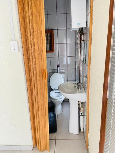 a bathroom with a toilet and a sink at Harmony Spaces in Kempton Park