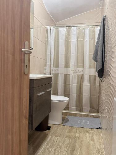 a bathroom with a toilet sink and a shower at Anna's House in Kos Town