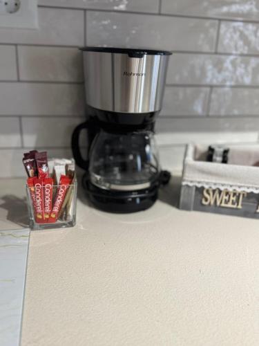 a blender sitting on a counter next to a container of sugar packets at Anna's House in Kos Town