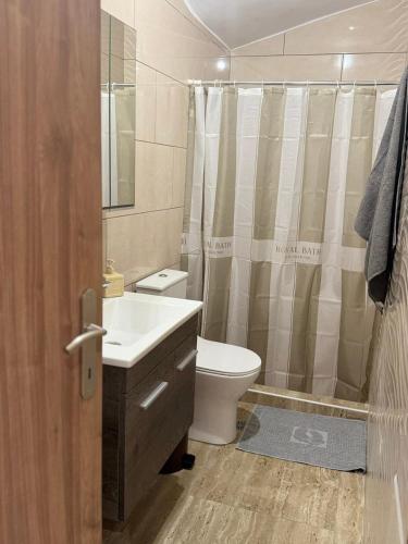 a bathroom with a toilet and a sink and a shower at Anna's House in Kos Town