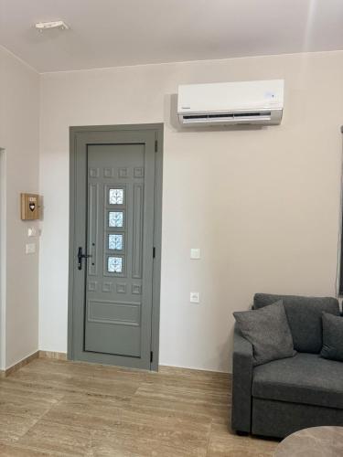 a living room with a door and a air conditioner at Anna's House in Kos Town