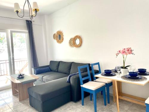 a living room with a couch and a table at Marias Apartment in Pefkohori