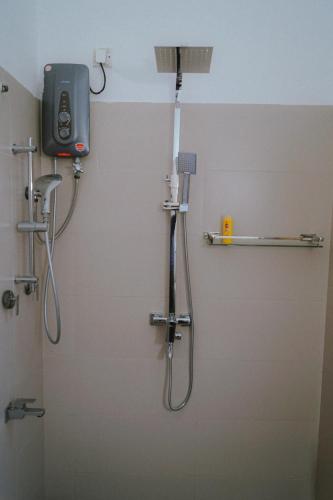 a bathroom with a shower with a shower head and a shower at Kandy Villa in Kandy