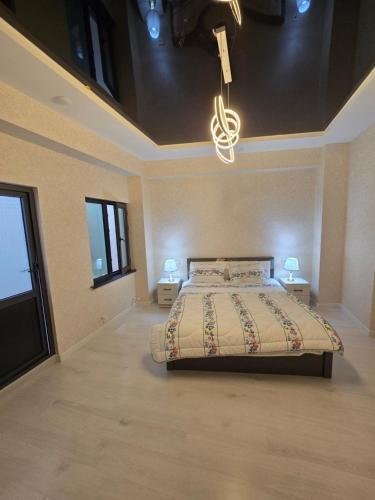 a bedroom with a bed with two night stands and two lamps at Luxs Apartments in Tashkent with kitchen for 8-10persons ул Шоший64 in Tashkent