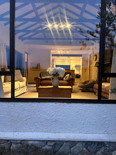 a living room with a couch and a vase of flowers at Private home, downtown Wanaka in Wanaka